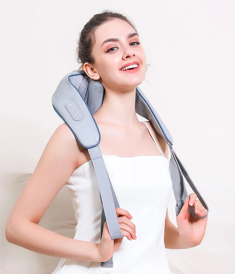 Smiling woman wearing electric shoulder and neck massager with adjustable straps, designed for muscle relaxation and pain relief